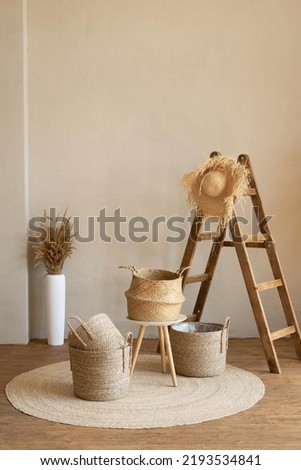 Various wicker baskets for interior decoration stand on the floor in a modern living room.