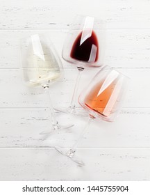 Various Wine Glasses On Wooden Table. Red, Rose And White Wines. Top View Flat Lay