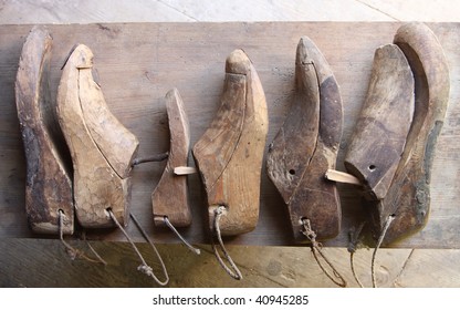 Various wooden shoe lasts in a row