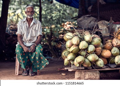 Varkala, Kerala, India – November 30, 2017: Portrait Of Unidentified Indian Man With Coconuts. Daily Lifestyle In Rural Area In South India.