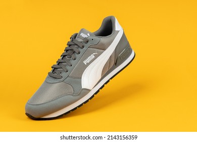 Varna , Bulgaria - AUGUST 18, 2021. PUMA Sport Shoe On Yellow Background. Puma, A Major German Multinational Company. Product Shot