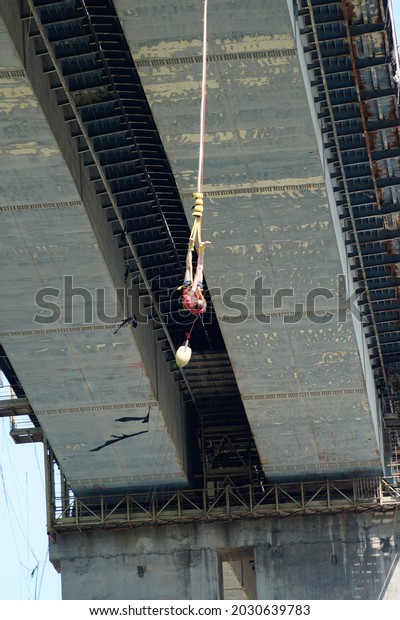 Varna, Bulgaria - August, 21, 2021: a man\
jumping from a road bridge with an elastic\
band