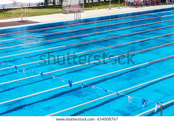 VARNA, BULGARIA -\
CIRCA 2017: Sports swimming pool with dividing paths for\
competition without swimmers. Cleaning the pool and preparing the\
Olympic sports pool for\
competitions