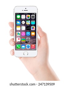 Varna, Bulgaria - December 07, 2013: Female Hand Holding Apple Silver IPhone 5S Displaying IOS 8 Mobile Operating System, Designed By Apple Inc. Isolated On White Background.