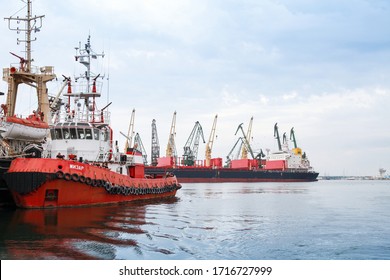 Varna, Bulgaria - July 16, 2014 - Red Tug Boat With Crew Is Moored In Main Port Of Varna