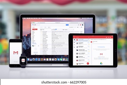 Varna, Bulgaria - May 23, 2017: Google Gmail page on the Apple MacBook, Gmail app on iPad Pro, Gmail splash screen with logo on iPhone 7 and notification icon on Apple Watch. Office desk concept.
