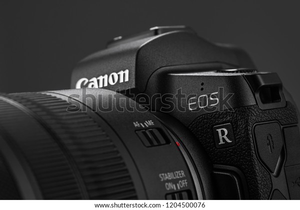 Varna, Bulgaria - October 11,2018: Image of\
Canon EOS R Mirrorless Digital Camera with Canon EF 24-105mm f4L IS\
USM lens on a black background. Canon is the world largest SLR\
camera manufacturer.
