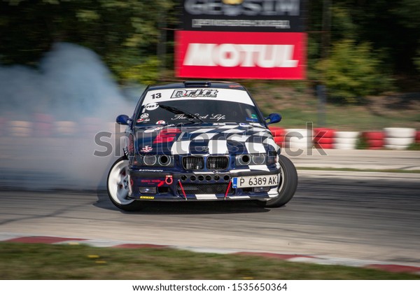 Varna, Bulgaria - October 14, 2018: Drift of\
Bulgaria. Challenge Battle BMW Turbo E36 with M power Engine. Full\
throttle drifting. Side view of one of the best drift cars ever. A\
lot of smoke