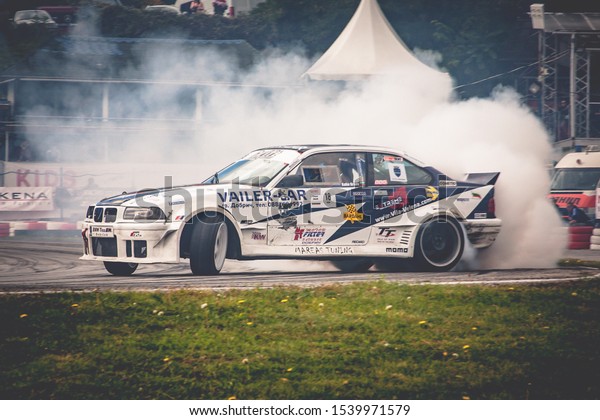 Varna,\
Bulgaria - October 14, 2018: Drift of Bulgaria. Challenge Battle\
BMW E36 M3 Turbo with M power Engine. Full throttle drifting. Side\
view, big angle drift. A lot of smoke. Rev\
limiter