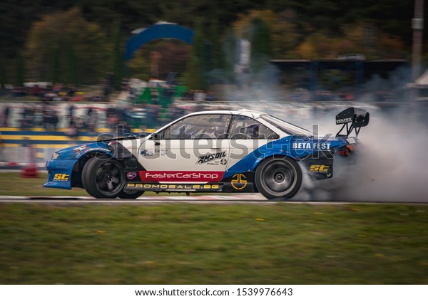 Varna, Bulgaria - October 14, 2018: Drift of\
Bulgaria. Challenge Battle Nissan 200sx s14 Turbo with 2jz power\
Engine. Full throttle drifting. Side view, big angle drift. A lot\
of smoke. Rev limiter