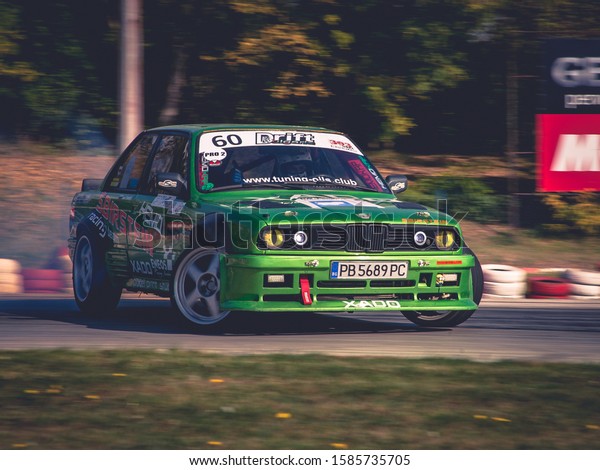 Varna,\
Bulgaria - October 14, 2018: Drift of Bulgaria. Challenge Battle\
BMW E30 Turbo with M3 Engine. Full throttle drifting. Front view of\
one of the best drift cars ever. Big drift\
angle\
