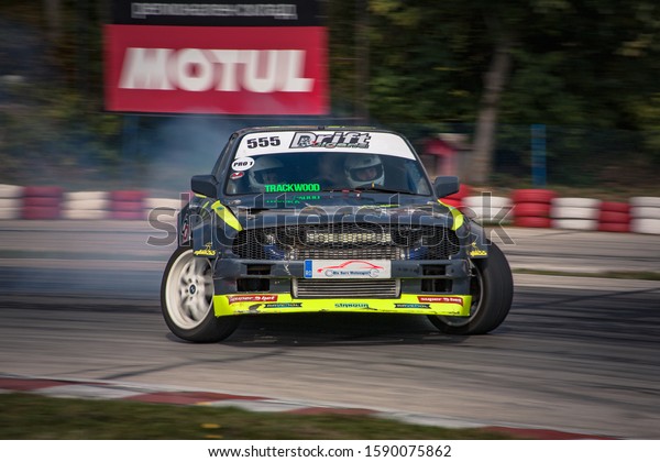 Varna,\
Bulgaria - October 14, 2018: Drift of Bulgaria. Challenge Battle\
BMW E30 Turbo with V8 Engine. Full throttle drifting. Front view of\
one of the best drift cars ever. A lot of\
smoke\
