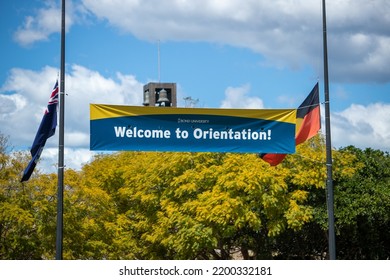 Varsity Lakes, Queensland, Australia. September, 10 2022. Bond University Welcome To Orientation Sign At Main Entrance. Flags At Half Mast After Queen Elizabeth II Death