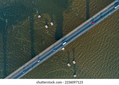 Varvarovsky bridge at dawn, Nikolaev city, Ukraine. Barge with cargo floating on the Dnieper. - Shutterstock ID 2236097123