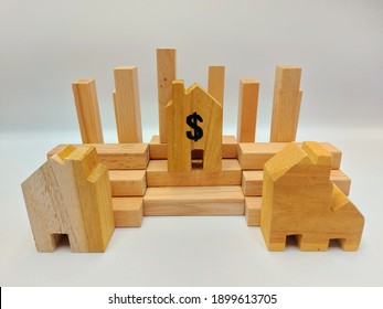 Varying House Shaped Wooden Blocks Stacked And Staggered To Represent The Housing Market, Trends And The Pricing