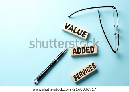 VAS - Value Added Services text on wooden block ,blue background