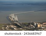 Vasco da Gama Bridge from above. Aerial photo with this long cable-stayed bridge, impressive architecture and construction over Tagus river in Lisbon, Portugal.