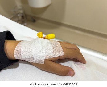 Vascular Access On The Hand Of Young Sick Girl At The Hospital Bed