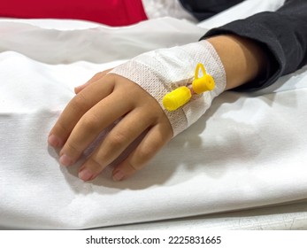 Vascular Access On The Hand Of Young Sick Girl At The Hospital Bed