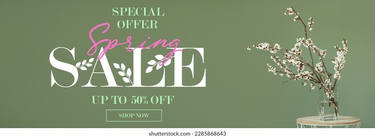 Vase with beautiful blossoming tree branches on table against green background. Spring sale - Powered by Shutterstock