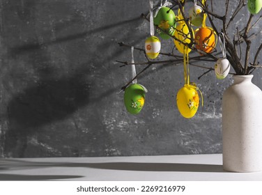 Vase with branches decorated with Easter eggs. Easter decoration, space for a text. - Shutterstock ID 2269216979
