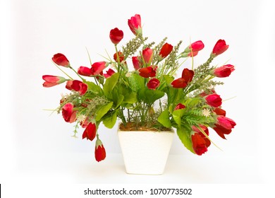 Vase Of Fake Flowers On White Background.