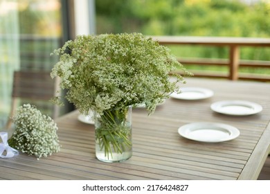 Vase On Table. Dining Table On Veranda. Lunch In Summer. White Plates On Wooden Table.