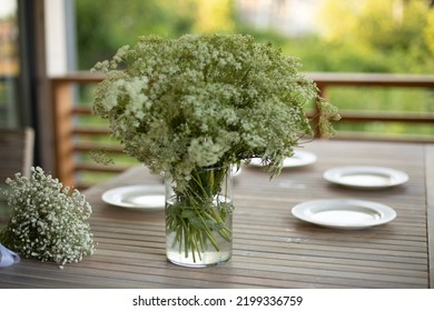 Vase On Table. Dining Table On Veranda. Lunch In Summer. White Plates On Wooden Table.