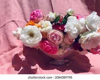 Vase Of Pretty Roses On Pink Linen Background