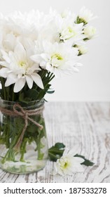 Vase With White Chrysanthemum On A Wooden Background