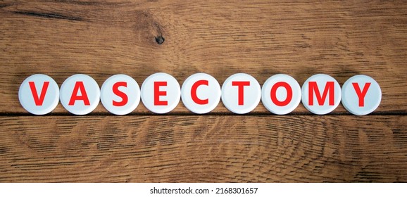 Vasectomy symbol. Concept words Vasectomy on white circles. Beautiful wooden table wooden background. Medical and vasectomy problem concept. Conceptual image. Copy space.