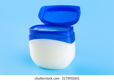 Vaseline Or Petroleum Jelly In A Clear Jar On Blue Background With Copy Space For Text. Skin Care Ointment