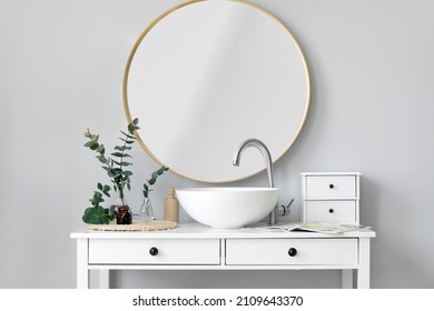 Vases With Green Eucalyptus Branches And Sink On Table In Bathroom