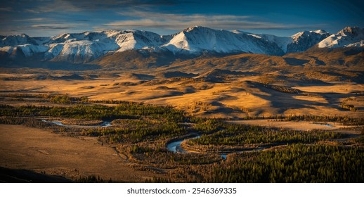 Vast Altai mountains landscape during autumn, showcasing golden plains and snow-capped peaks under dramatic skies. Serene atmosphere with natural beauty and tranquility. - Powered by Shutterstock