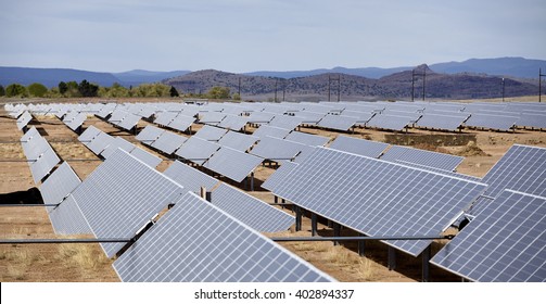 vast array of solar electric panel power utility industry grid on open countryside landscape