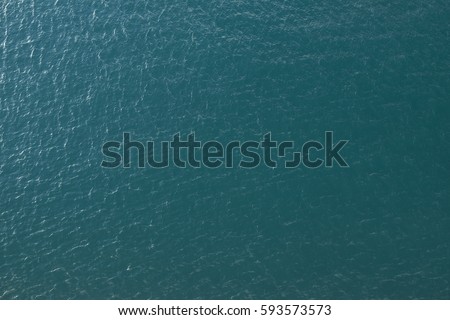 Vast blue ocean background with moderate waves looking straight down