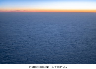 Vast cloudscape under a gradient sky, symbolizing travel and freedom at altitude