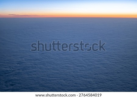 Vast cloudscape under a gradient sky, symbolizing travel and freedom at altitude
