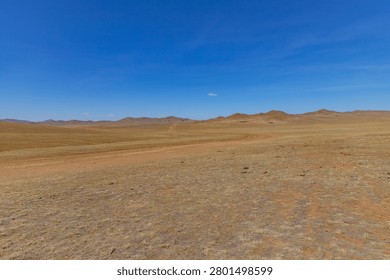 A vast desert plain with distant rolling hills near Ulaanbaatar, Mongolia