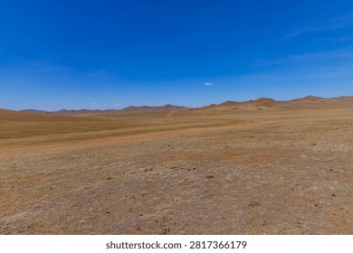 A vast desert plain with distant rolling hills near Ulaanbaatar, Mongolia