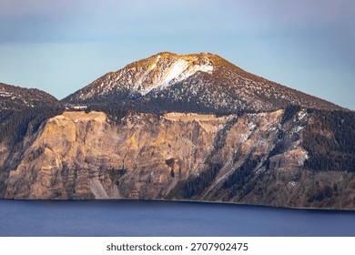 A vast, expansive panoramic view of distant mountain ranges and valleys, observed from the high vantage point of the Crater Lake National Park rim in Oregon