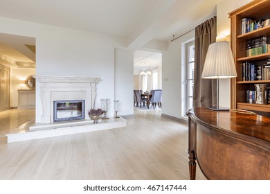 Vast fireplace room with panelled flooring and a classic escritoire in the first ground - Shutterstock ID 467147444