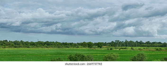 Vast green fields under a cloudy rural sky.