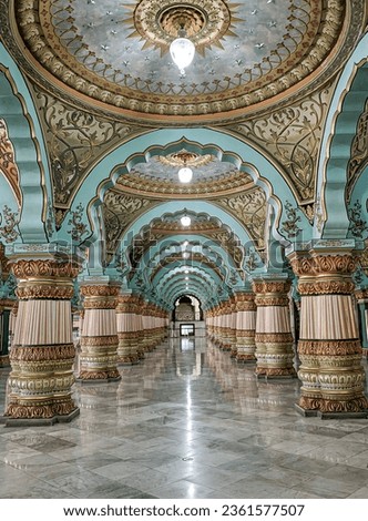 The vast palace showcases ornate pillars, grand hallways with opulent decor and soft lighting. Mysore palace, India.