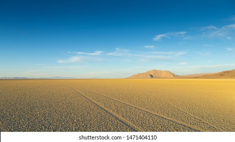 Vast Playa at Black Rock Desert with Tire Tracks on Empty Cracked Mud.