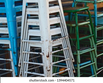 A Vast Quantity of Miscellaneous Stacked Vintage Stools in Tarnished Condition.