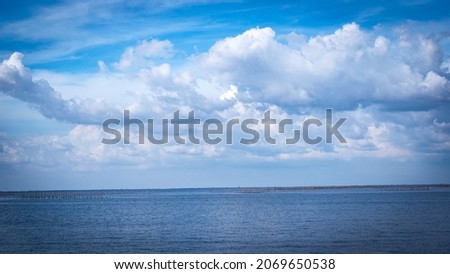 The vast sea with white clouds in the blue sky, beautiful nature