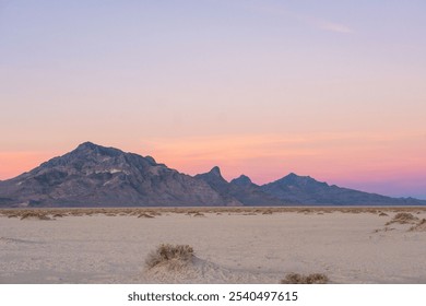 A vast, white expanse of Utah’s Bonneville Salt Flats under a clear blue sky. The flat salt crust reflects the horizon, creating a serene, minimalist scene of natural beauty and endless space. - Powered by Shutterstock