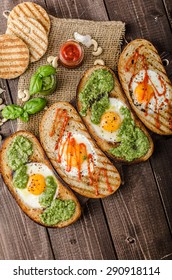 Vatiations of fried eggs inside bread, panini bread with pesto and hot sriracha sauce
