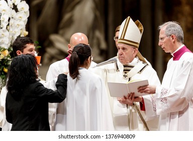 Vatican City, April 20, 2019. Pope Francis gives the confirmation to a faithful during the Easter vigil ceremony in St. Peter's Basilica.